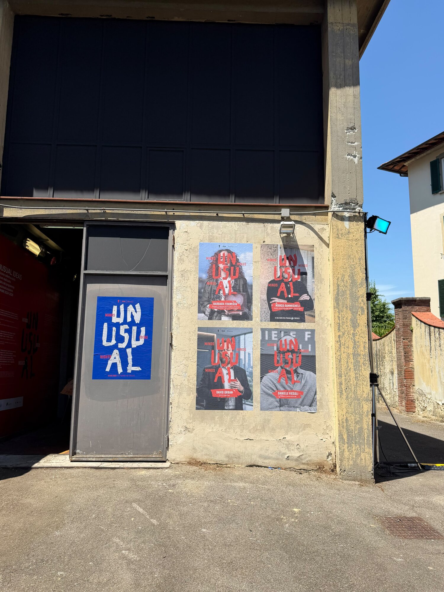 Posters for ISIA Firenze's UNUSUAL event on a wall in Via Pisana, with David Orban among the speakers